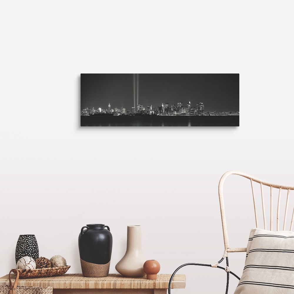 A farmhouse room featuring Panoramic vista of the New York City skyline in the evening, with beams of light from the World T...