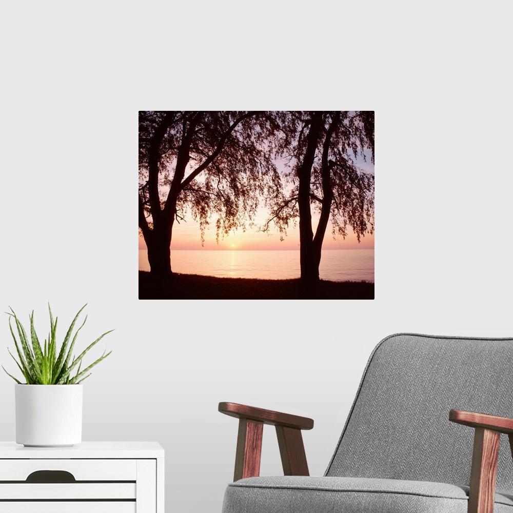 A modern room featuring New York, Sodus Bay, Lake Ontario, Sunset over a lake