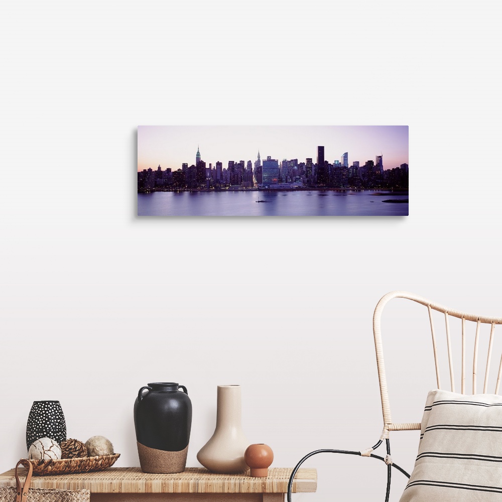 A farmhouse room featuring Panoramic wall docor of the New York City cityscape along a waterfront at sunset.