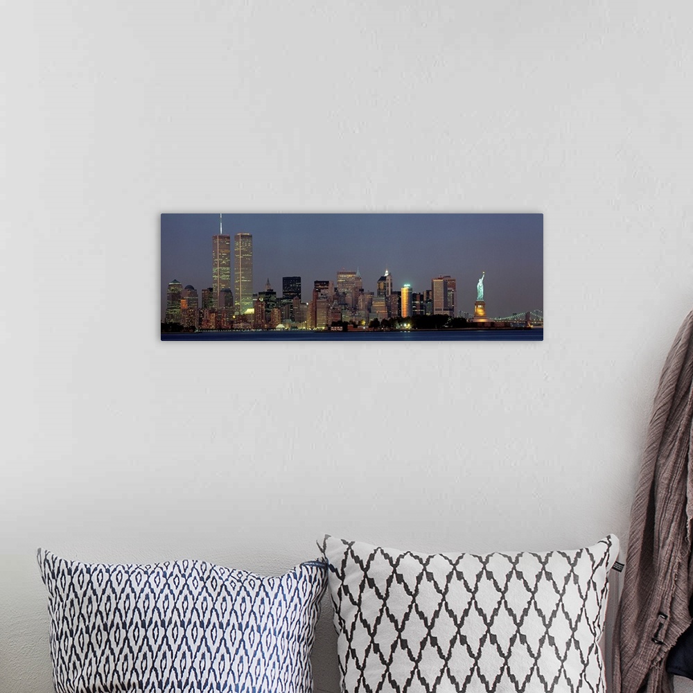 A bohemian room featuring Panoramic photograph of the New York skyline at night, with the Twin Towers and the Statue of Lib...