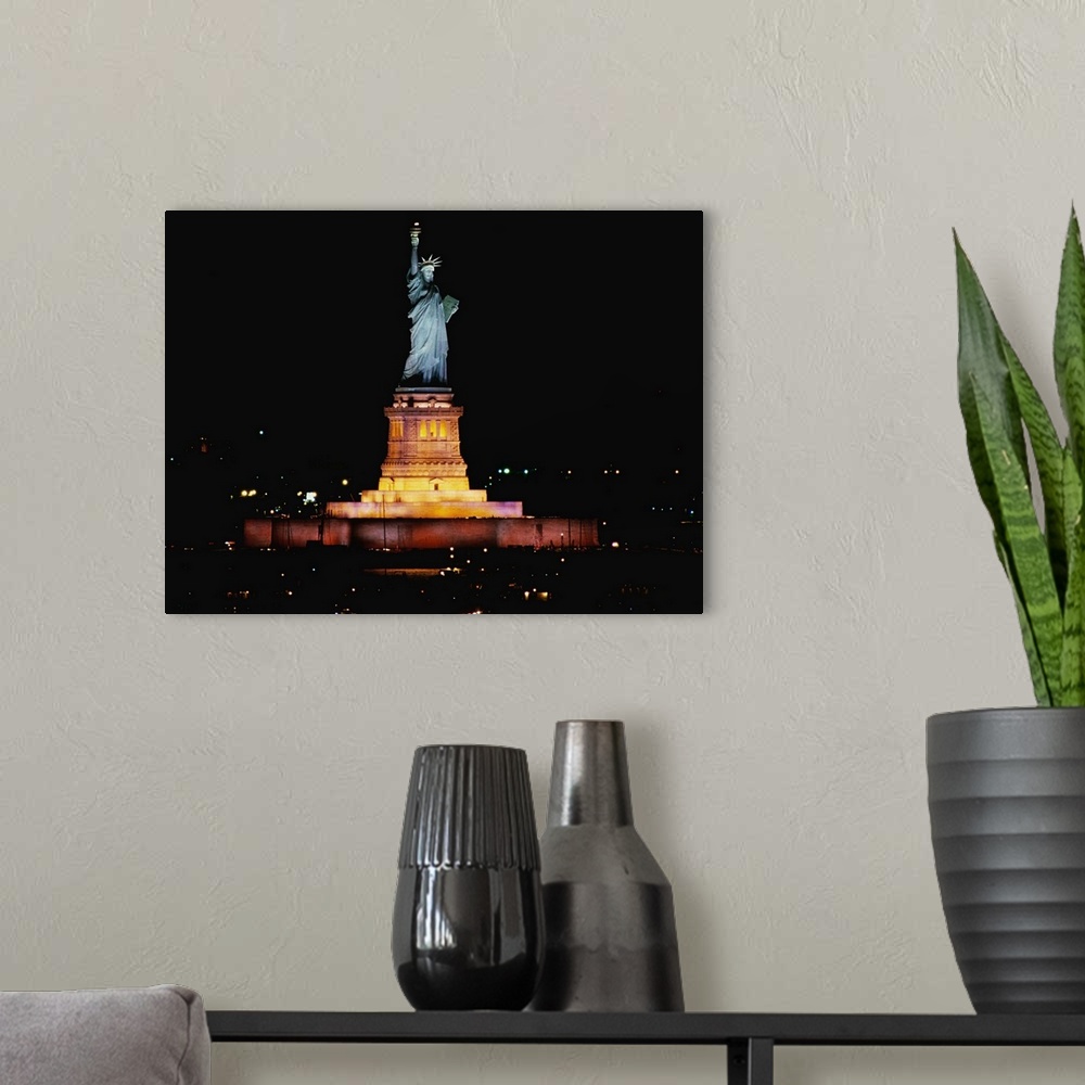 A modern room featuring Big photo on canvas of the Statue of Liberty at night lit up.