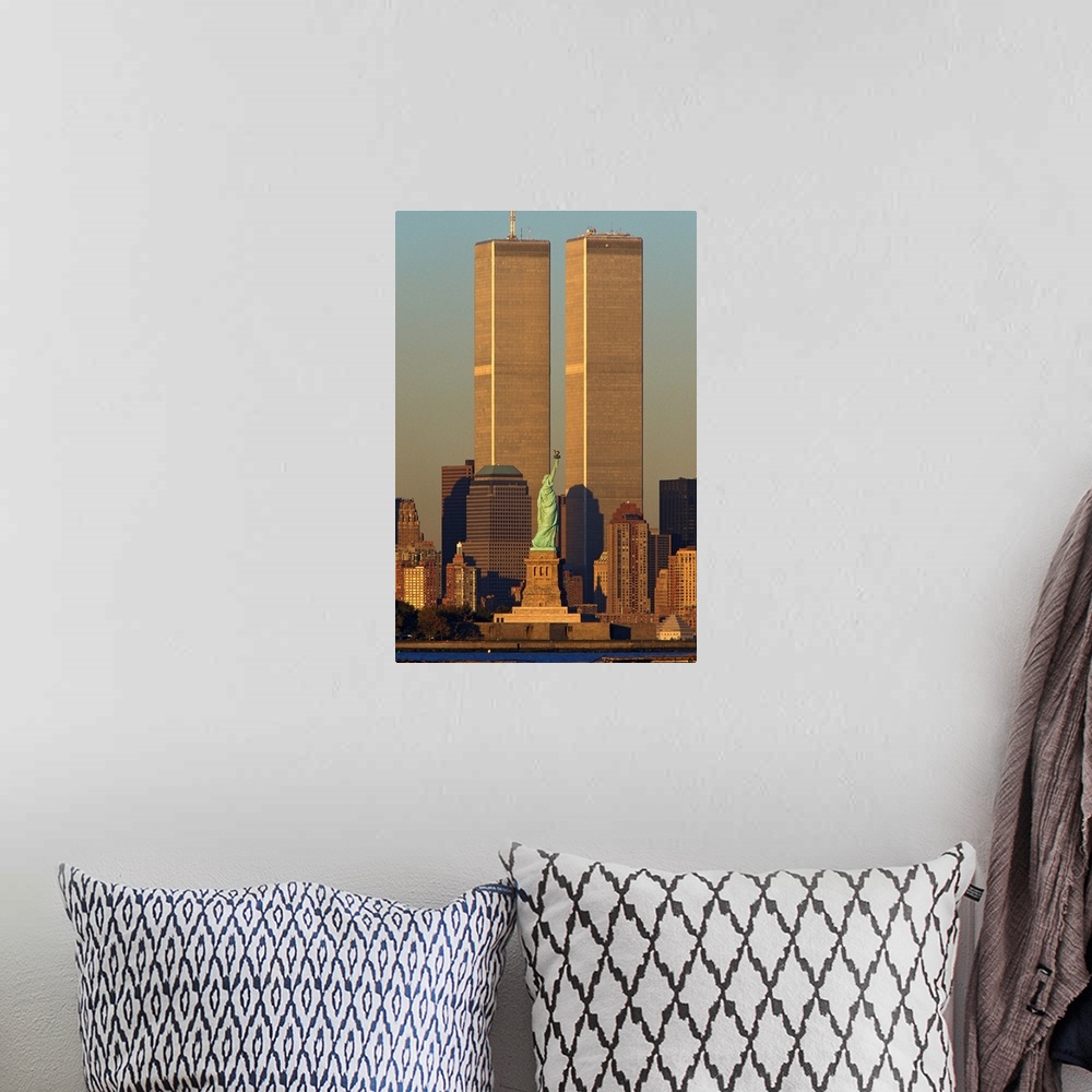 A bohemian room featuring Vertical photograph of the World Trade Center towering over Manhattan with the Statue of Liberty ...