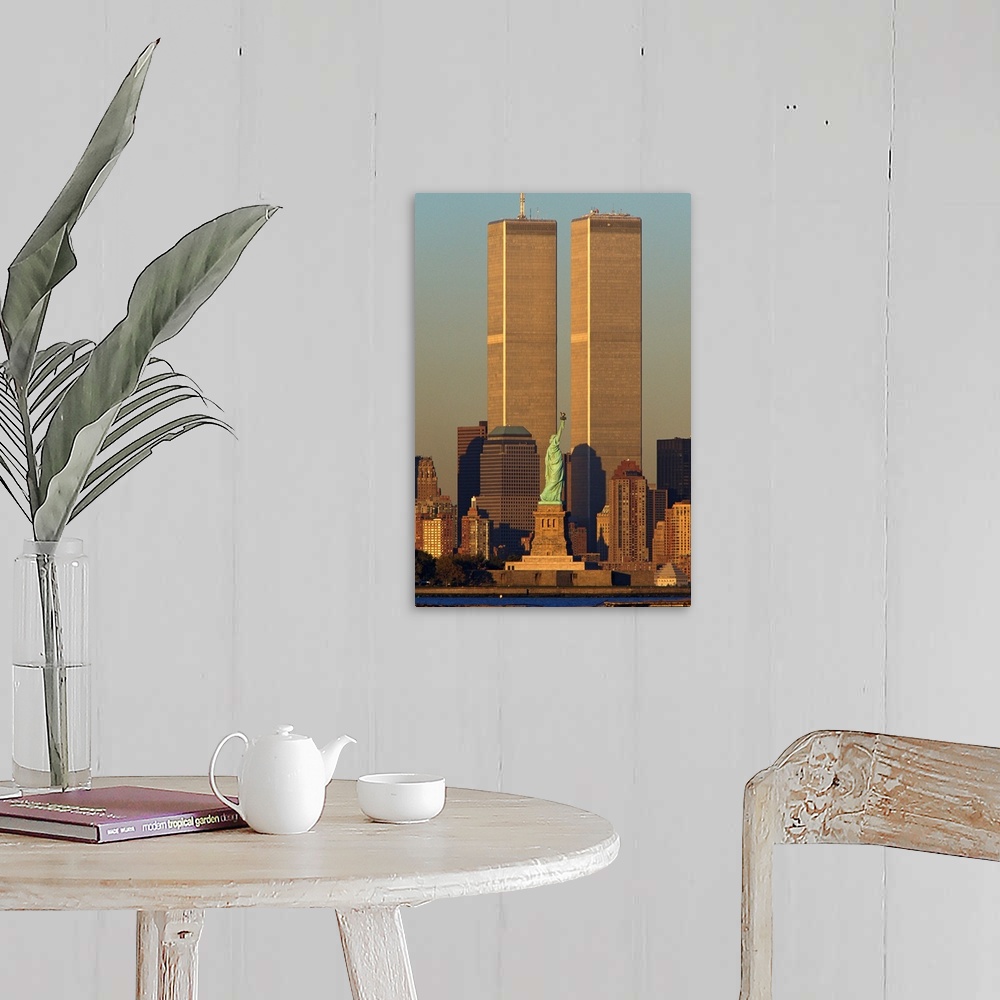 A farmhouse room featuring Vertical photograph of the World Trade Center towering over Manhattan with the Statue of Liberty ...