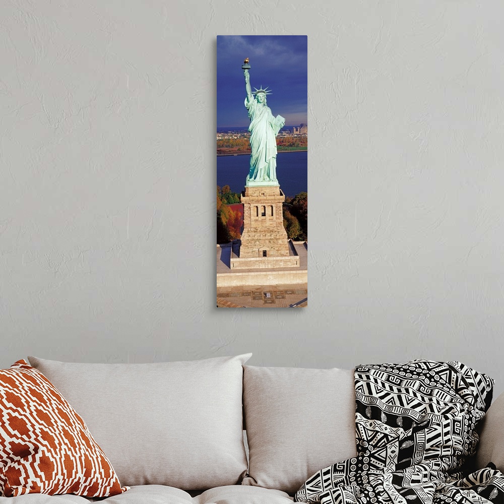 A bohemian room featuring Panoramic photograph displays a United States landmark sitting on an island found off the coast o...