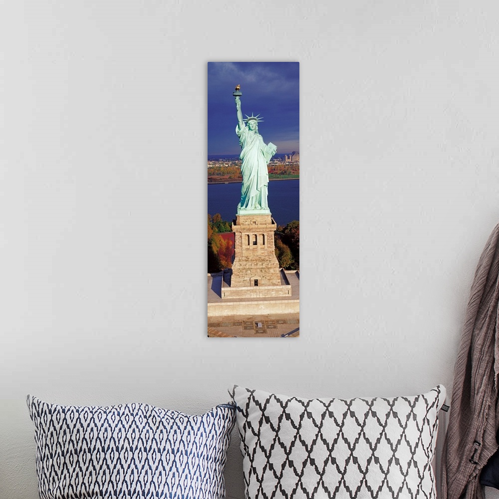 A bohemian room featuring Panoramic photograph displays a United States landmark sitting on an island found off the coast o...