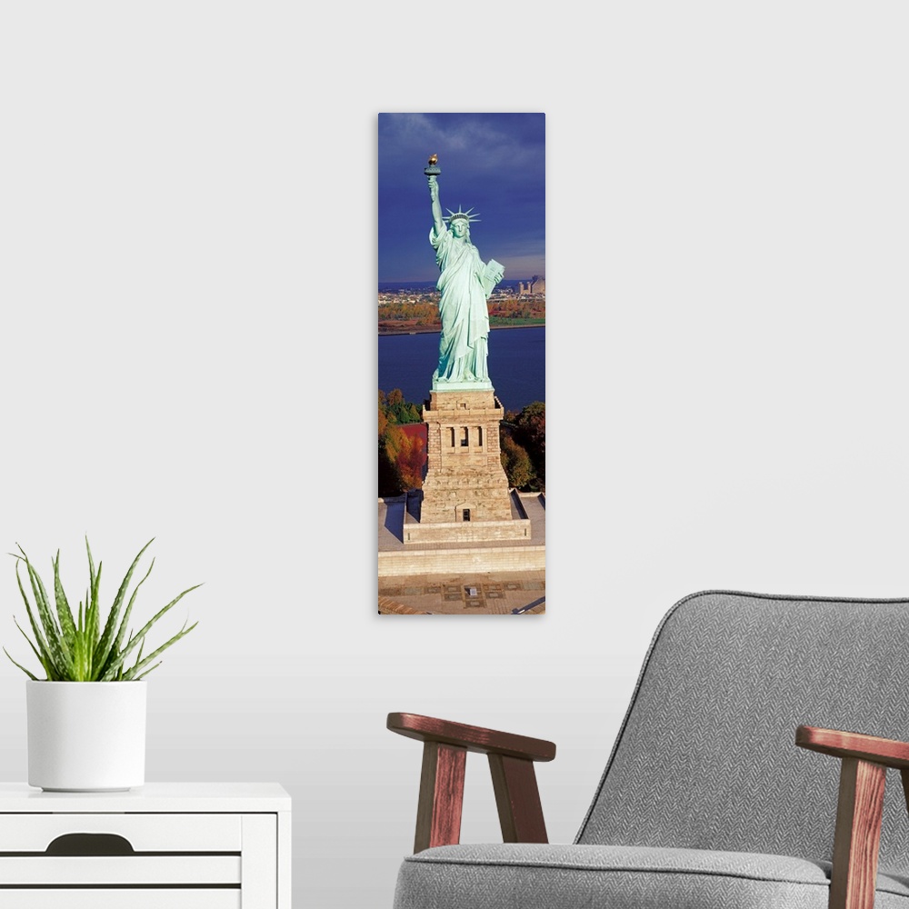 A modern room featuring Panoramic photograph displays a United States landmark sitting on an island found off the coast o...