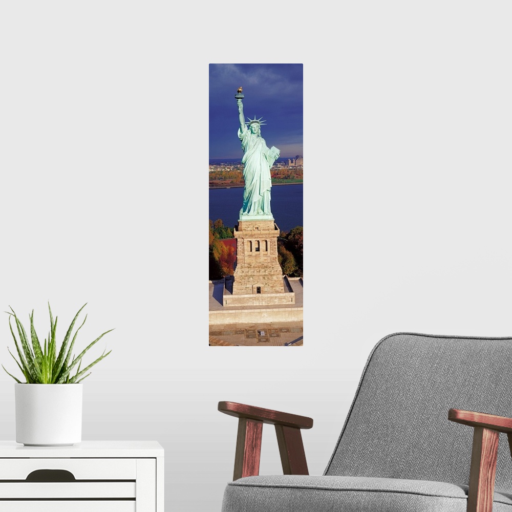 A modern room featuring Panoramic photograph displays a United States landmark sitting on an island found off the coast o...