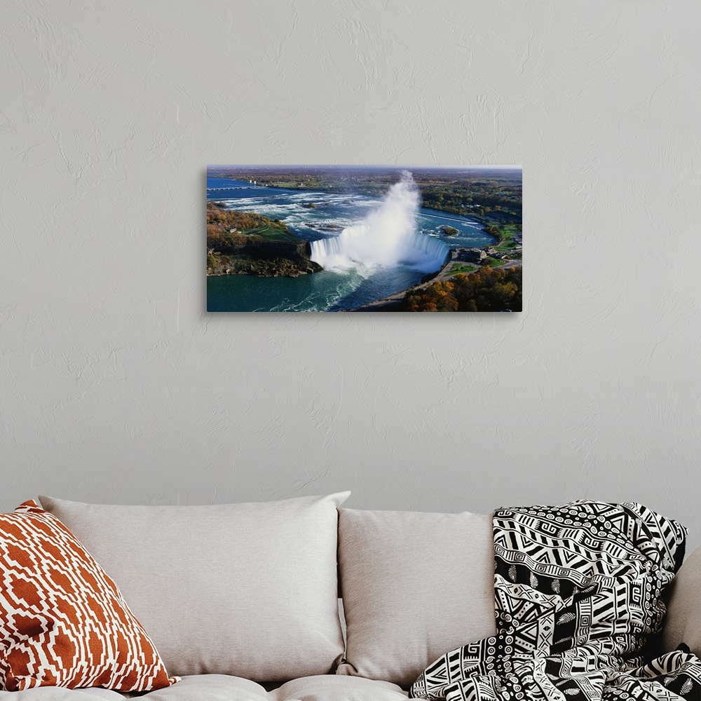 A bohemian room featuring Aerial photo of Niagara Falls lined by Canada on one side and New York on the other.