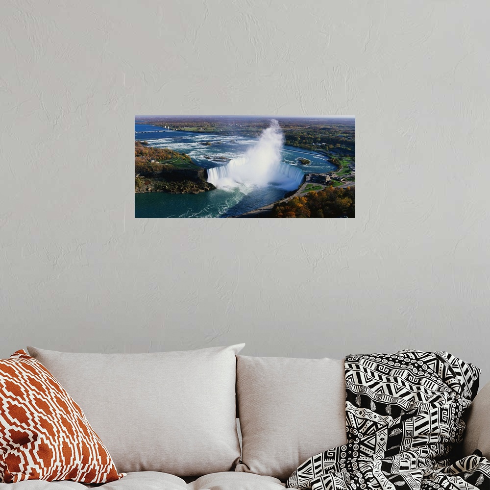 A bohemian room featuring Aerial photo of Niagara Falls lined by Canada on one side and New York on the other.