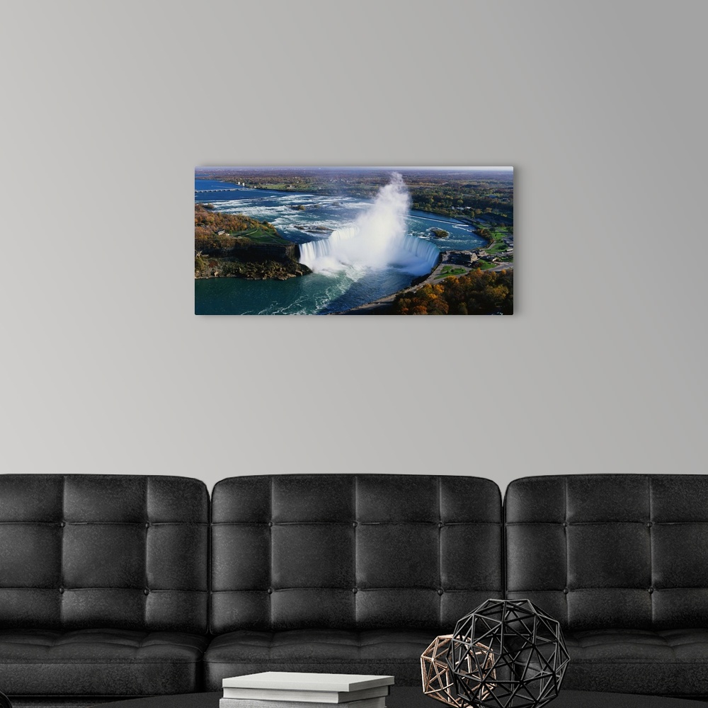 A modern room featuring Aerial photo of Niagara Falls lined by Canada on one side and New York on the other.