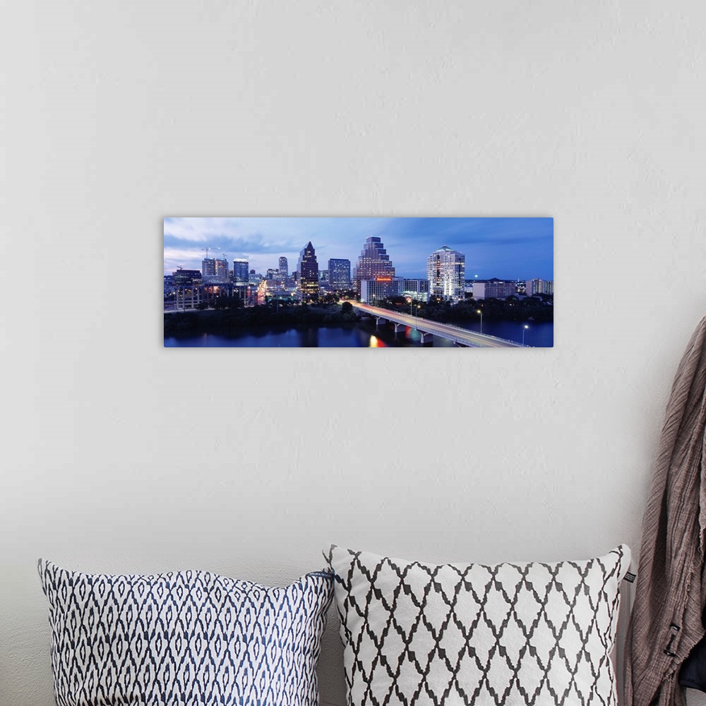 A bohemian room featuring Panoramic photograph taken within the capital city of Texas shows the skyline at nighttime sittin...