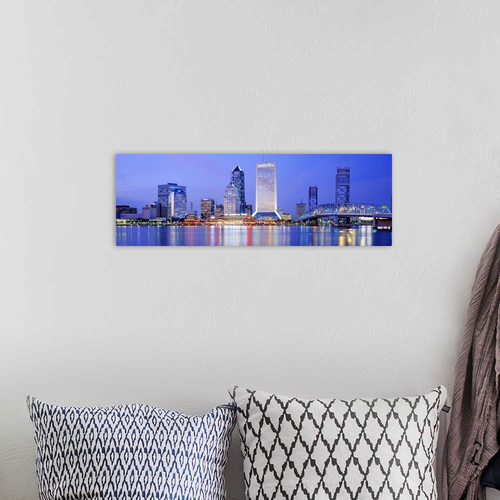 A bohemian room featuring This large panoramic photograph is of the Jacksonville skyline with it's buildings lit up at nigh...