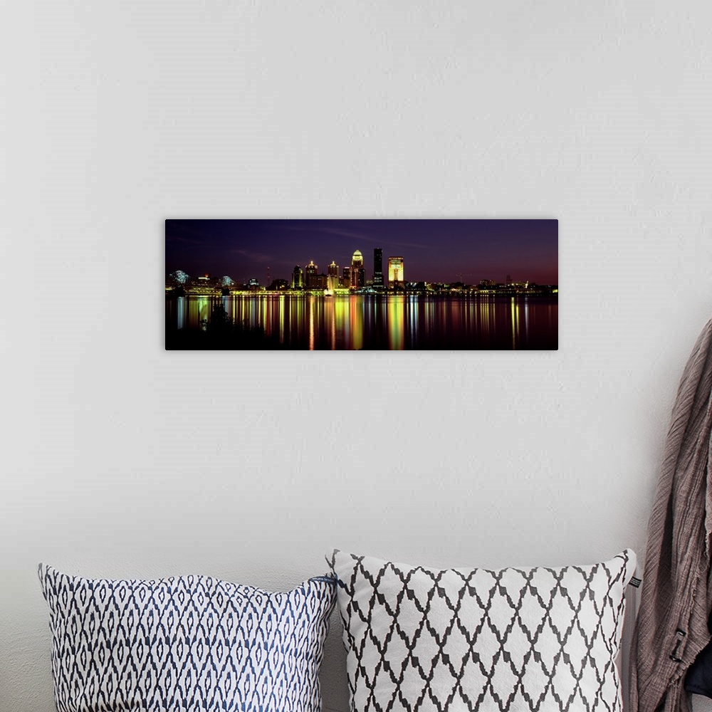 A bohemian room featuring Panoramic photograph displays the radiantly shining skyline of the largest city in Kentucky at ni...