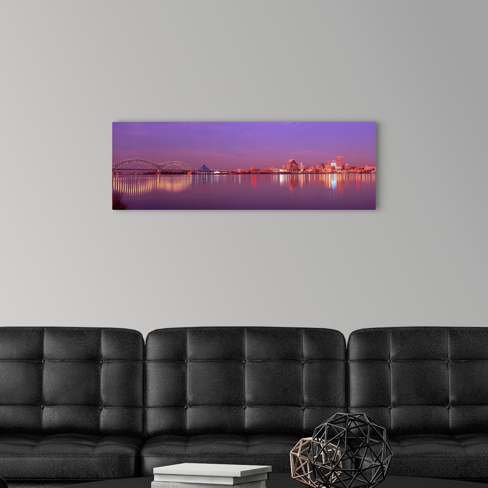 A modern room featuring This photographic wall art a panoramic cityscape of Memphis lights reflecting on the Mississippi ...