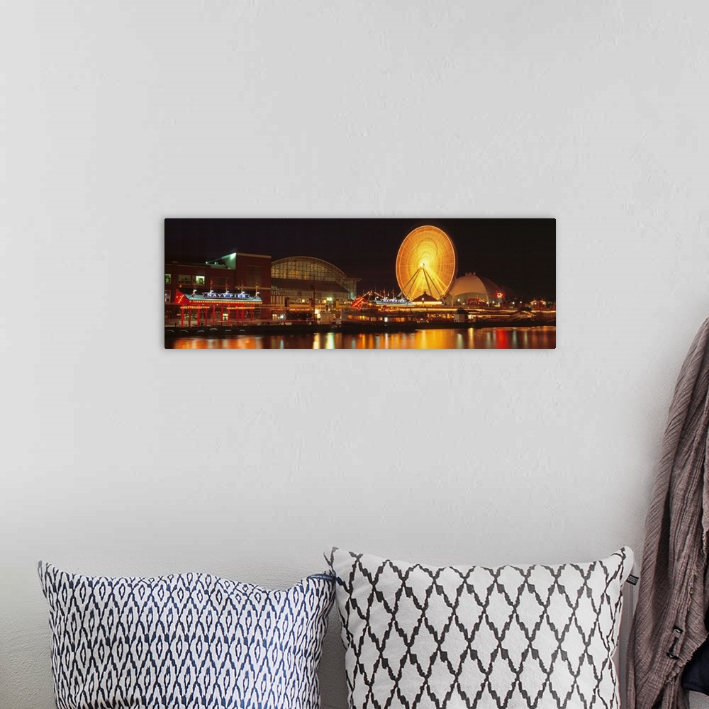 A bohemian room featuring Panoramic photo on canvas of the navy pier lit up at night along a waterfront with a ferris wheel.