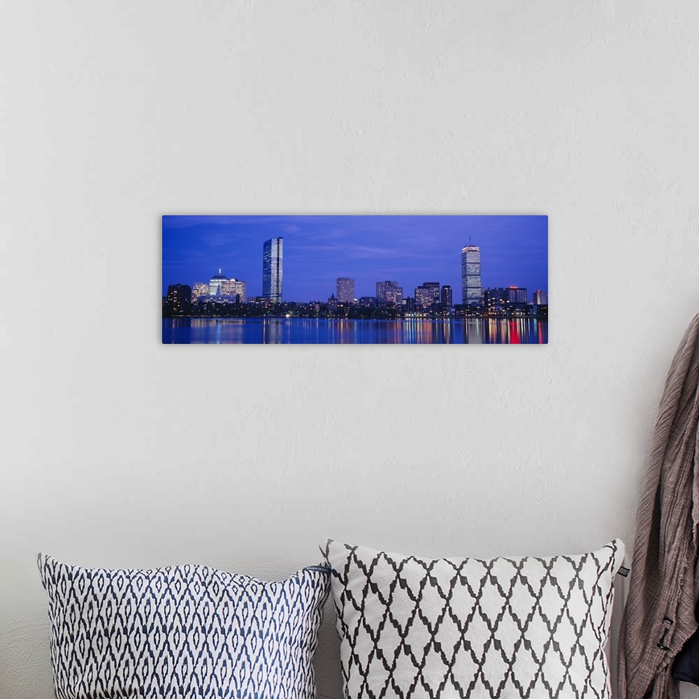 A bohemian room featuring Panoramic night skyline with building lights reflecting onto the waterfront.