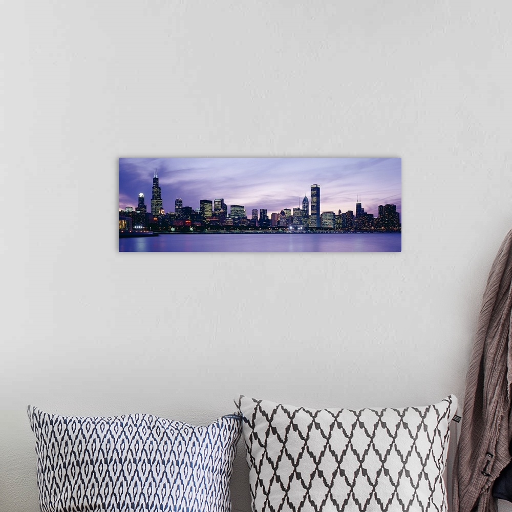 A bohemian room featuring Big canvas photo of an illuminated cityscape along a smooth waterfront at dusk.