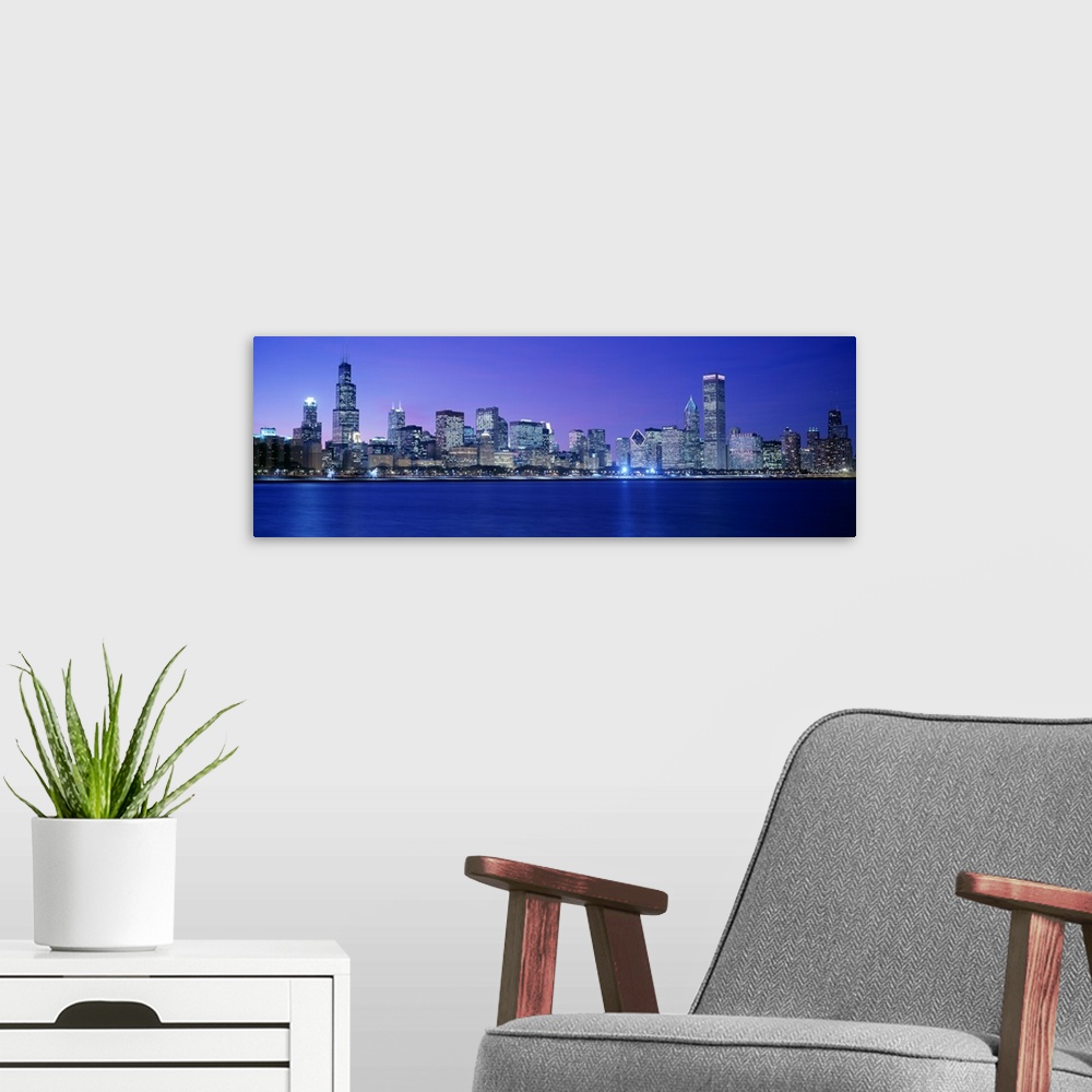 A modern room featuring Panoramic photograph displays the lively skyline of this landmark city located within the Midwest...