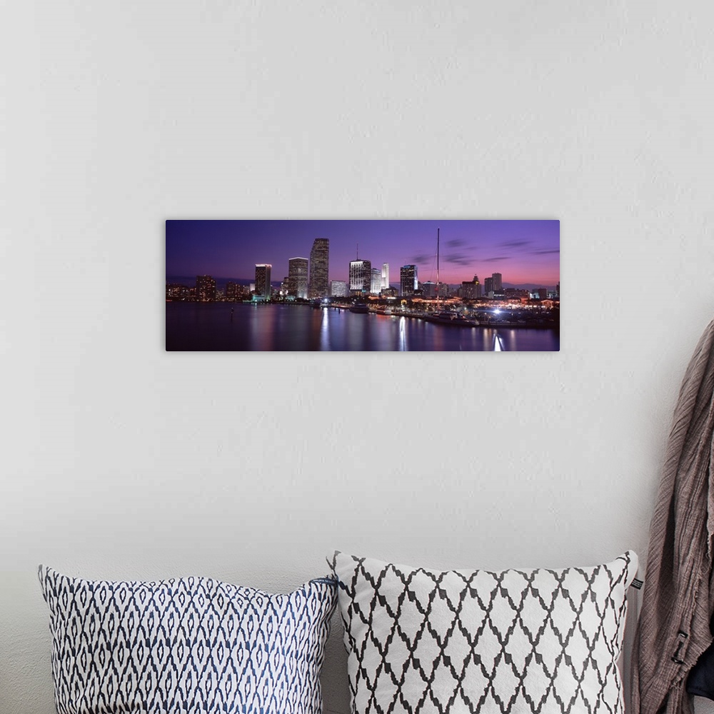 A bohemian room featuring This wall art shows the city skyline reflecting in the water of a panoramic photograph for the ho...