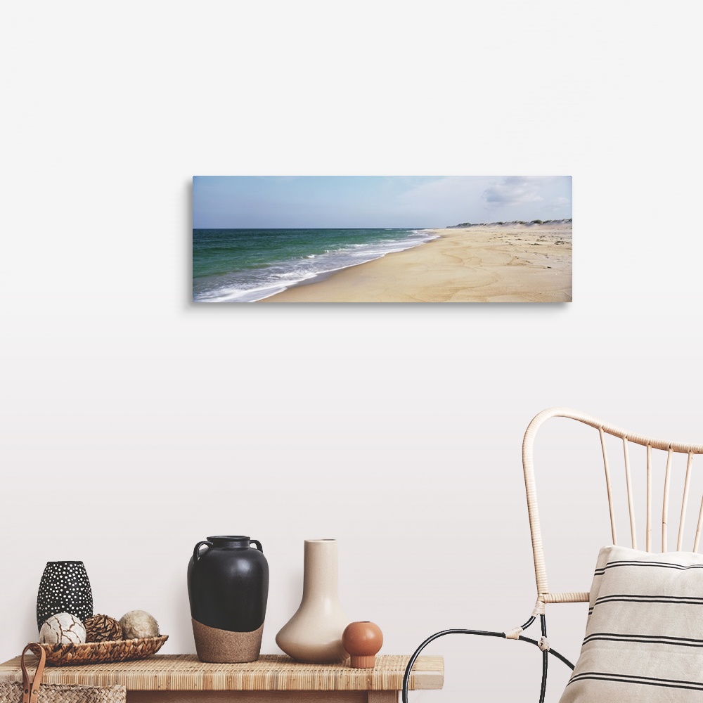 A farmhouse room featuring Panoramic photograph displays the Atlantic Ocean slowly coming into contact with a sandy shorelin...