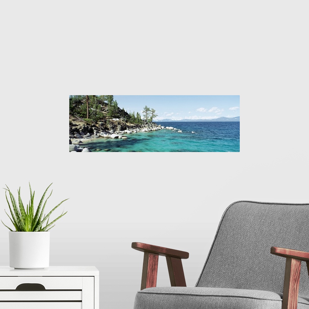A modern room featuring Panoramic photograph on a large wall hanging of the rocky North Shore of Lake Tahoe, the hillside...