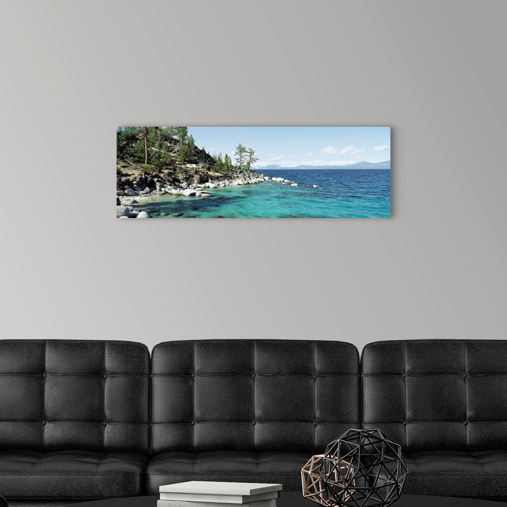 A modern room featuring Panoramic photograph on a large wall hanging of the rocky North Shore of Lake Tahoe, the hillside...
