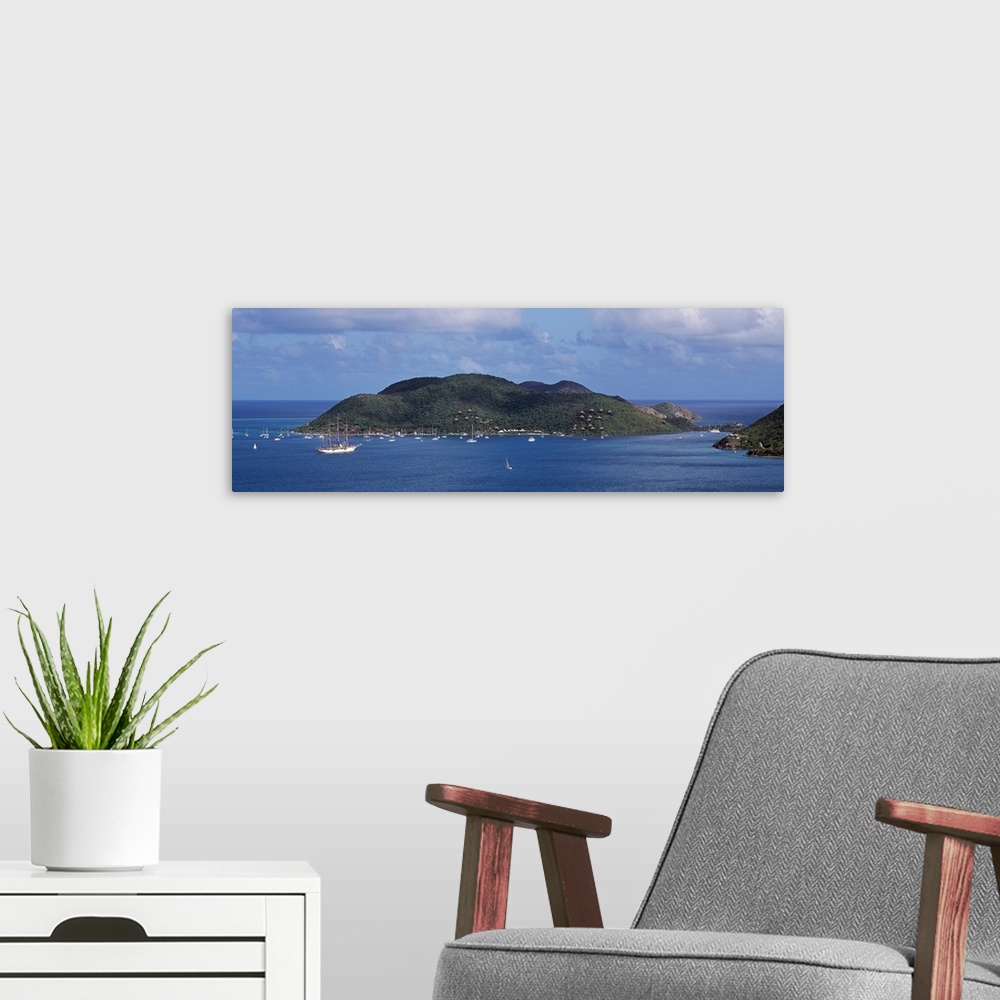A modern room featuring A large island is photographed in panoramic view with various bloats floating around the edge and...