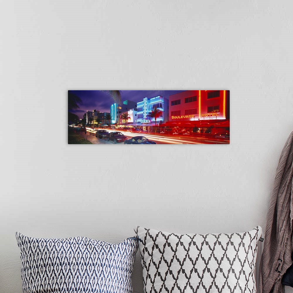 A bohemian room featuring Long horizontal photo print of a busy and lit up street in Miami.
