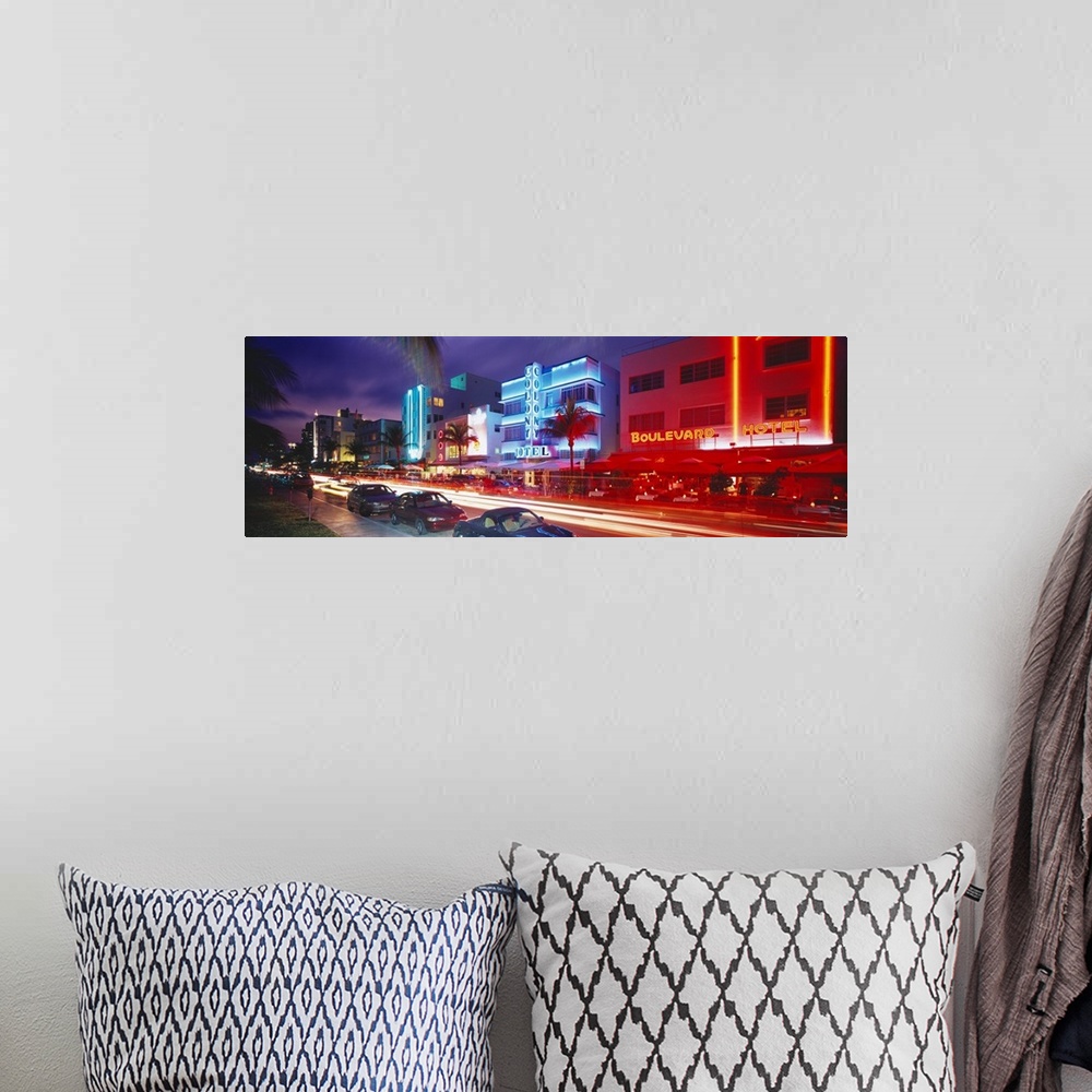 A bohemian room featuring Long horizontal photo print of a busy and lit up street in Miami.