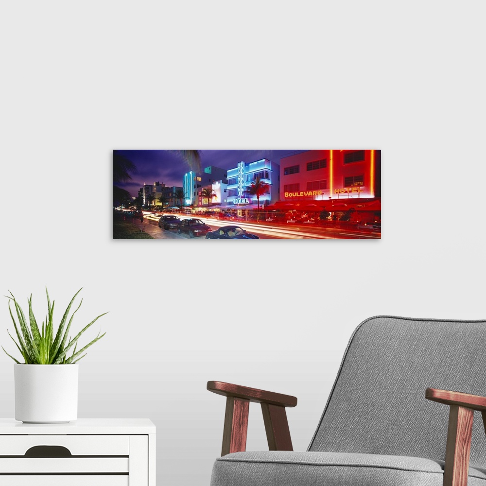 A modern room featuring Long horizontal photo print of a busy and lit up street in Miami.
