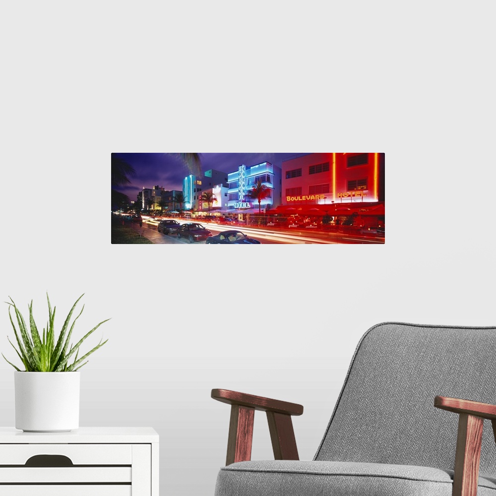 A modern room featuring Long horizontal photo print of a busy and lit up street in Miami.