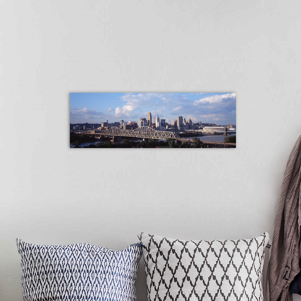 A bohemian room featuring Wide angle photograph taken of the Cincinnati skyline from a distance with a clear view of the br...