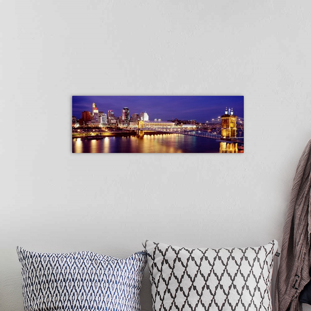 A bohemian room featuring Horizontal photograph on a large canvas of the night lights of Cincinnati's downtown waterfront a...