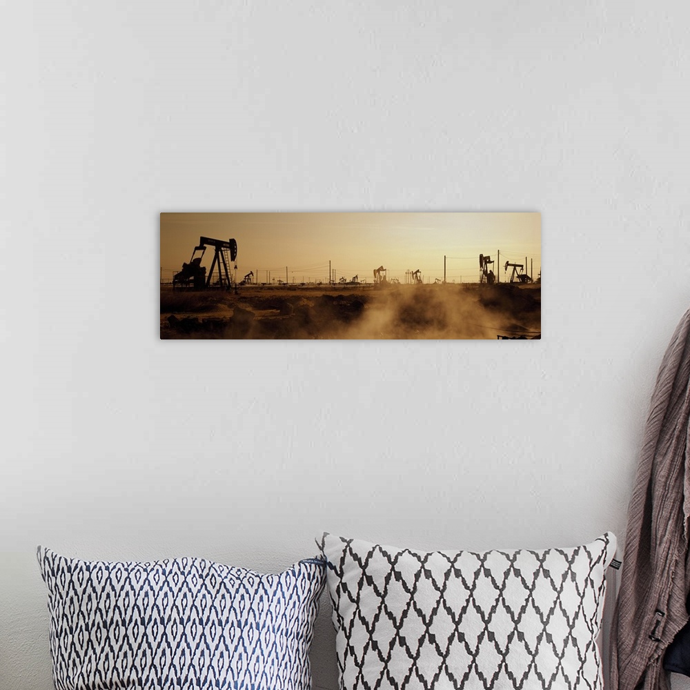 A bohemian room featuring Panoramic photograph of many oil drills in a vast filed at sunset in Maricopa, Kern County, Calif...