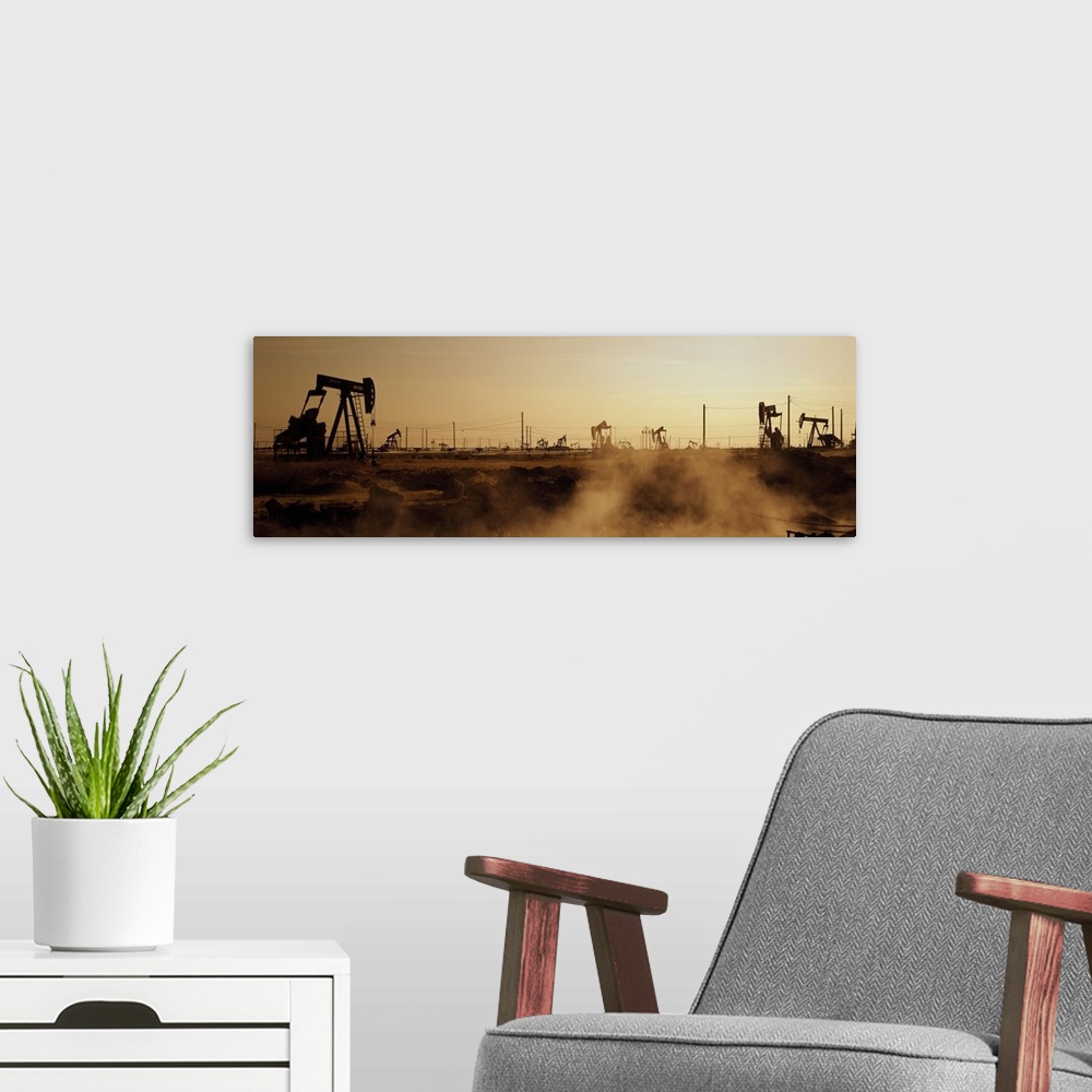 A modern room featuring Panoramic photograph of many oil drills in a vast filed at sunset in Maricopa, Kern County, Calif...