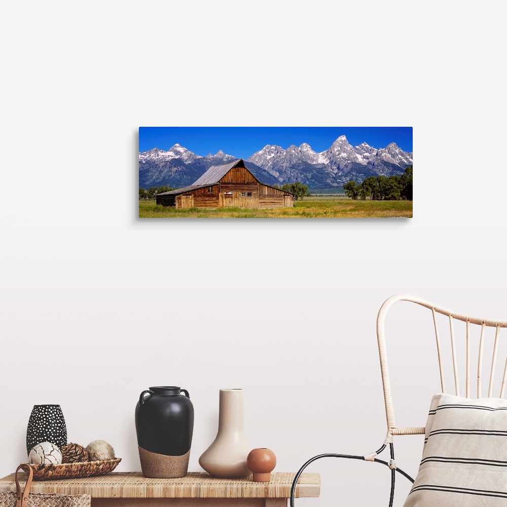 A farmhouse room featuring A panoramic landscape photograph of farmland, the T.A. Moulton barn, and the massive mountain pea...