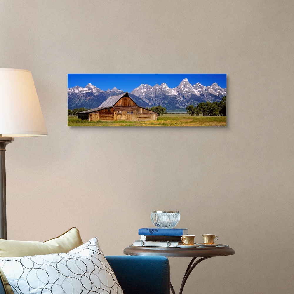 A traditional room featuring A panoramic landscape photograph of farmland, the T.A. Moulton barn, and the massive mountain pea...