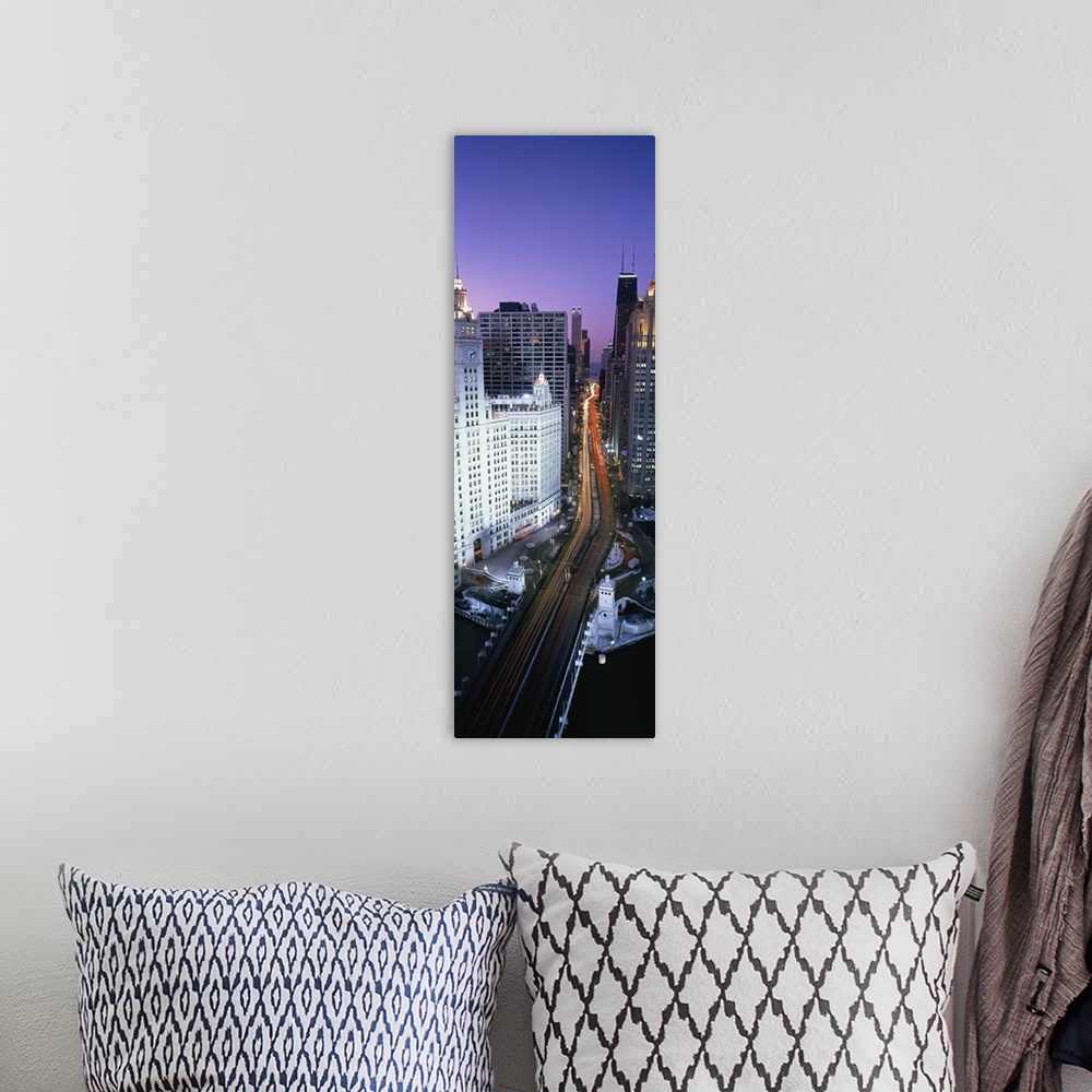A bohemian room featuring A photograph of a busy street going through downtown Chicago at night with the lights of the cars...