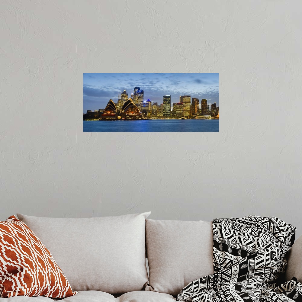 A bohemian room featuring Panoramic photograph taken at nighttime displays the brightly lit skyline and surrounding structu...