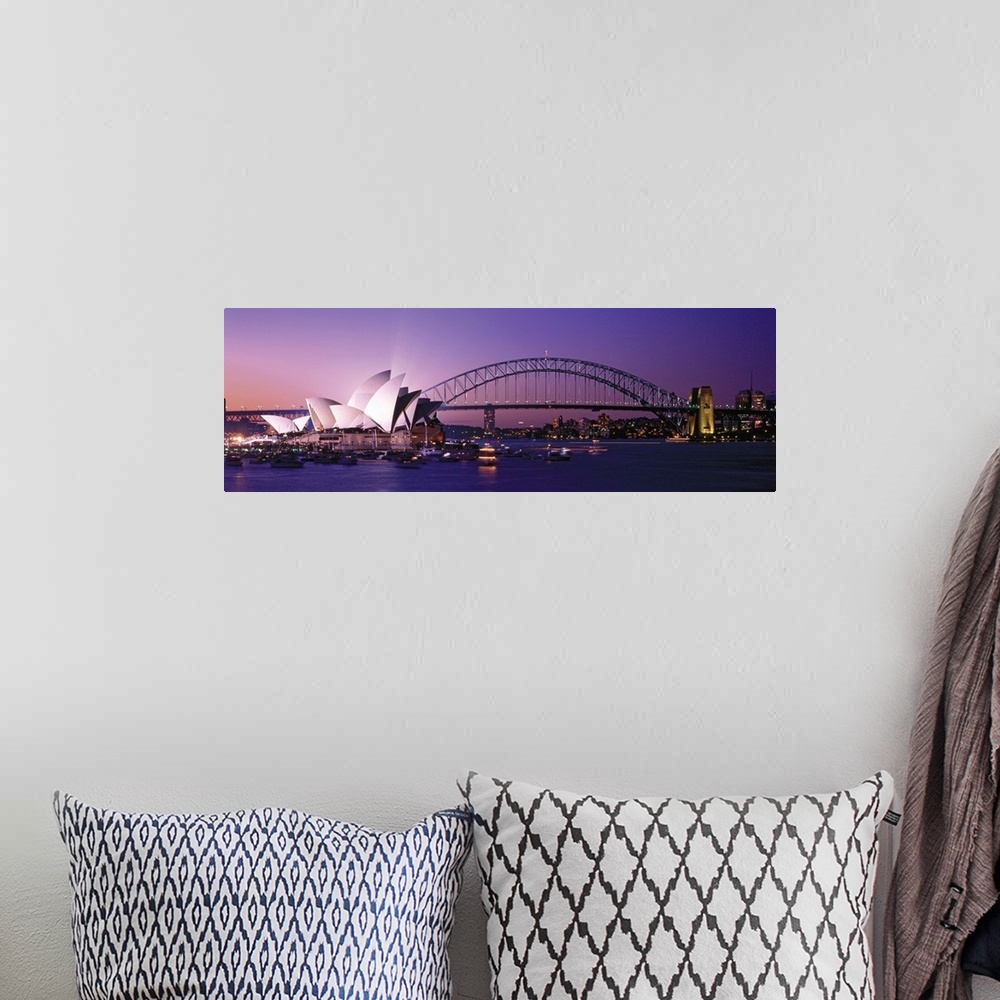 A bohemian room featuring Panoramic photograph of floating music house with city skyline and bridge in the distance at sunset.