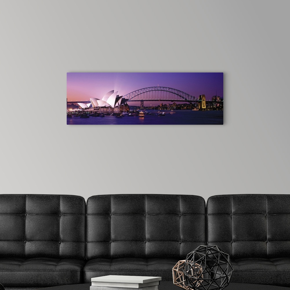 A modern room featuring Panoramic photograph of floating music house with city skyline and bridge in the distance at sunset.