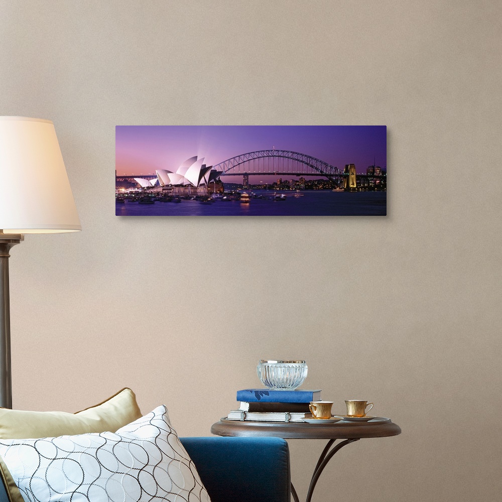 A traditional room featuring Panoramic photograph of floating music house with city skyline and bridge in the distance at sunset.