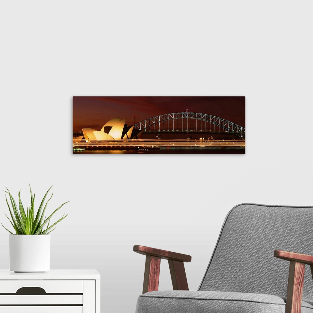 A modern room featuring Opera house lit up at night with light streaks, Sydney Harbor Bridge, Sydney Opera House, Sydney,...