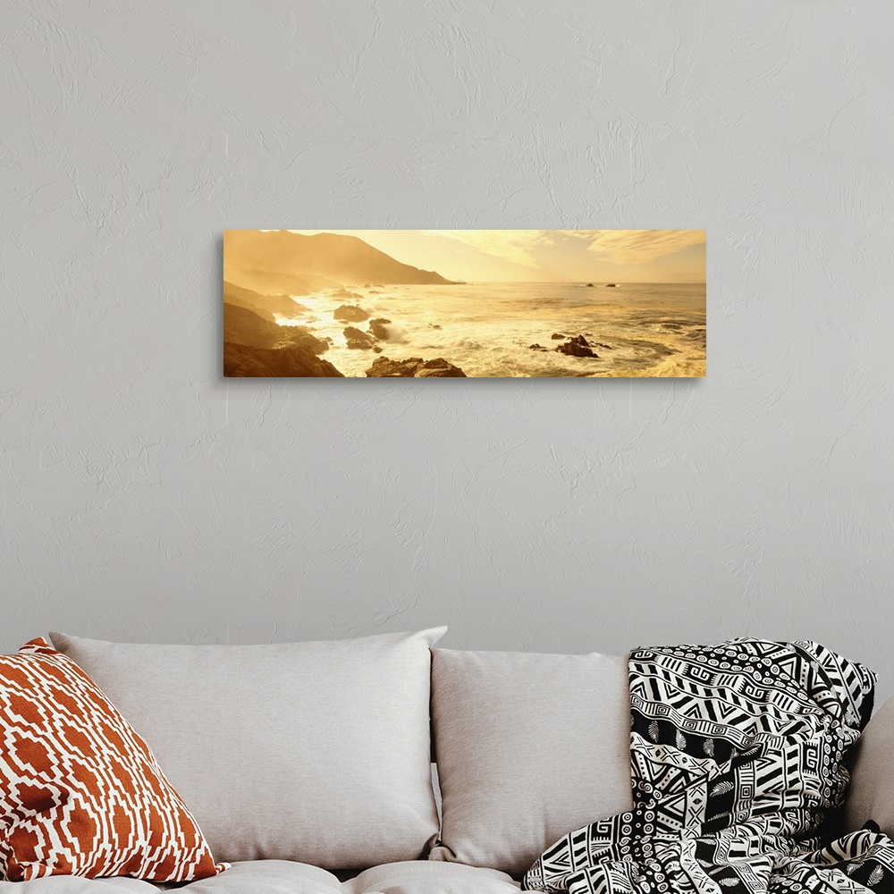 A bohemian room featuring Wide angle photograph on a big canvas of the Pacific Ocean along a rocky coast line in California...