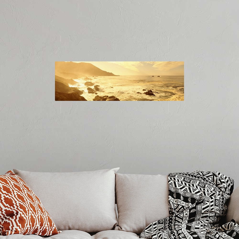 A bohemian room featuring Wide angle photograph on a big canvas of the Pacific Ocean along a rocky coast line in California...