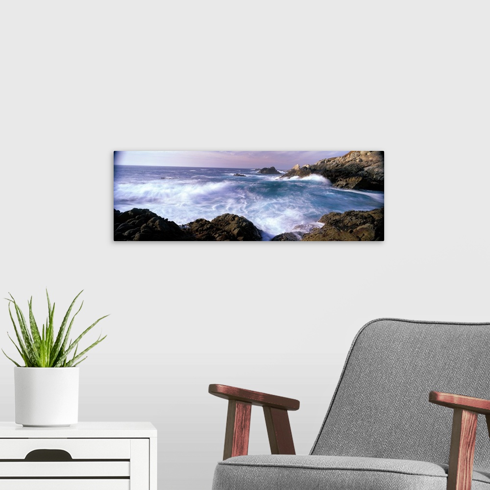 A modern room featuring Panoramic photograph on a large canvas of ocean waves crashing into the rocks near San Simeon Poi...