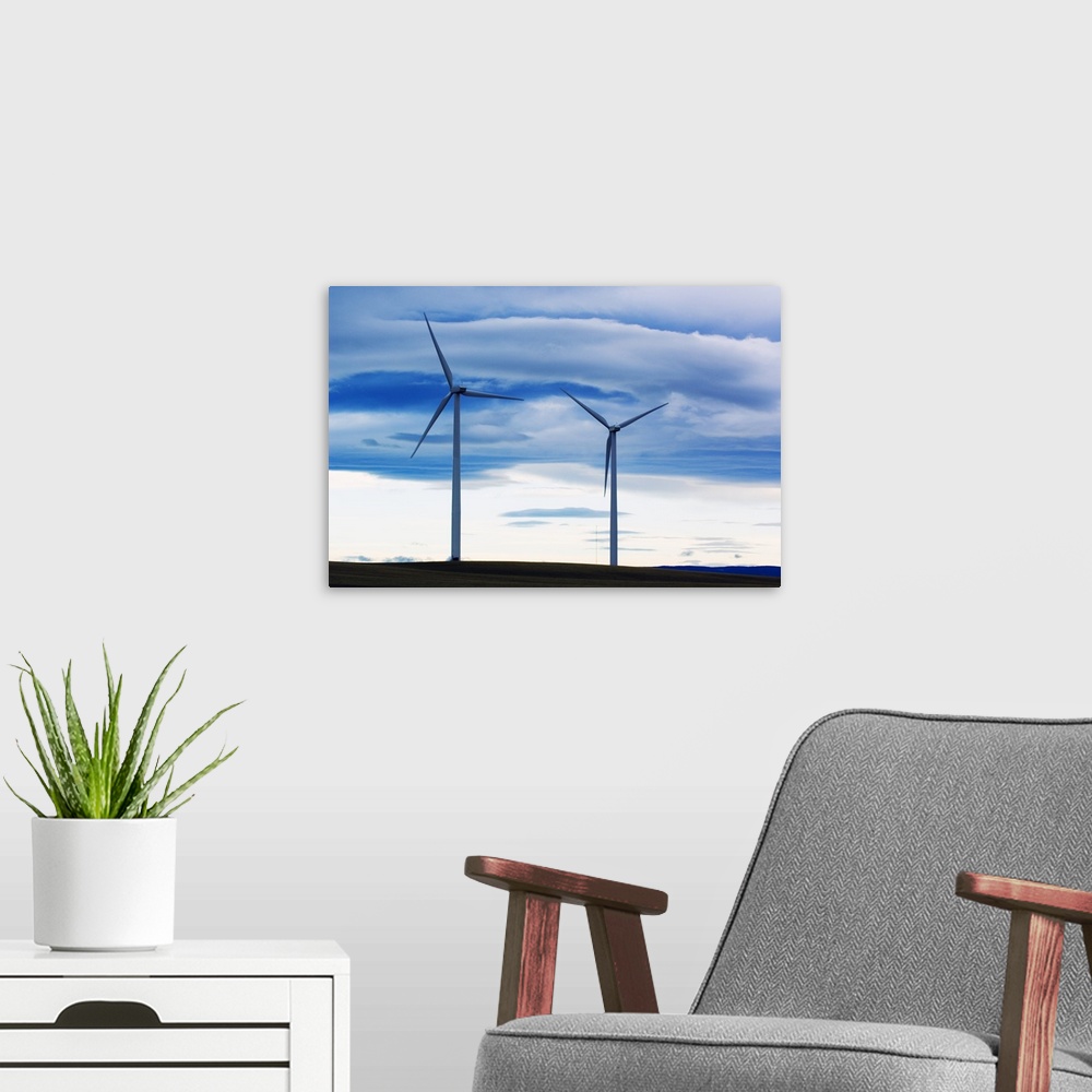 A modern room featuring Pair of wind farm turbines, cloudy sky, Montana