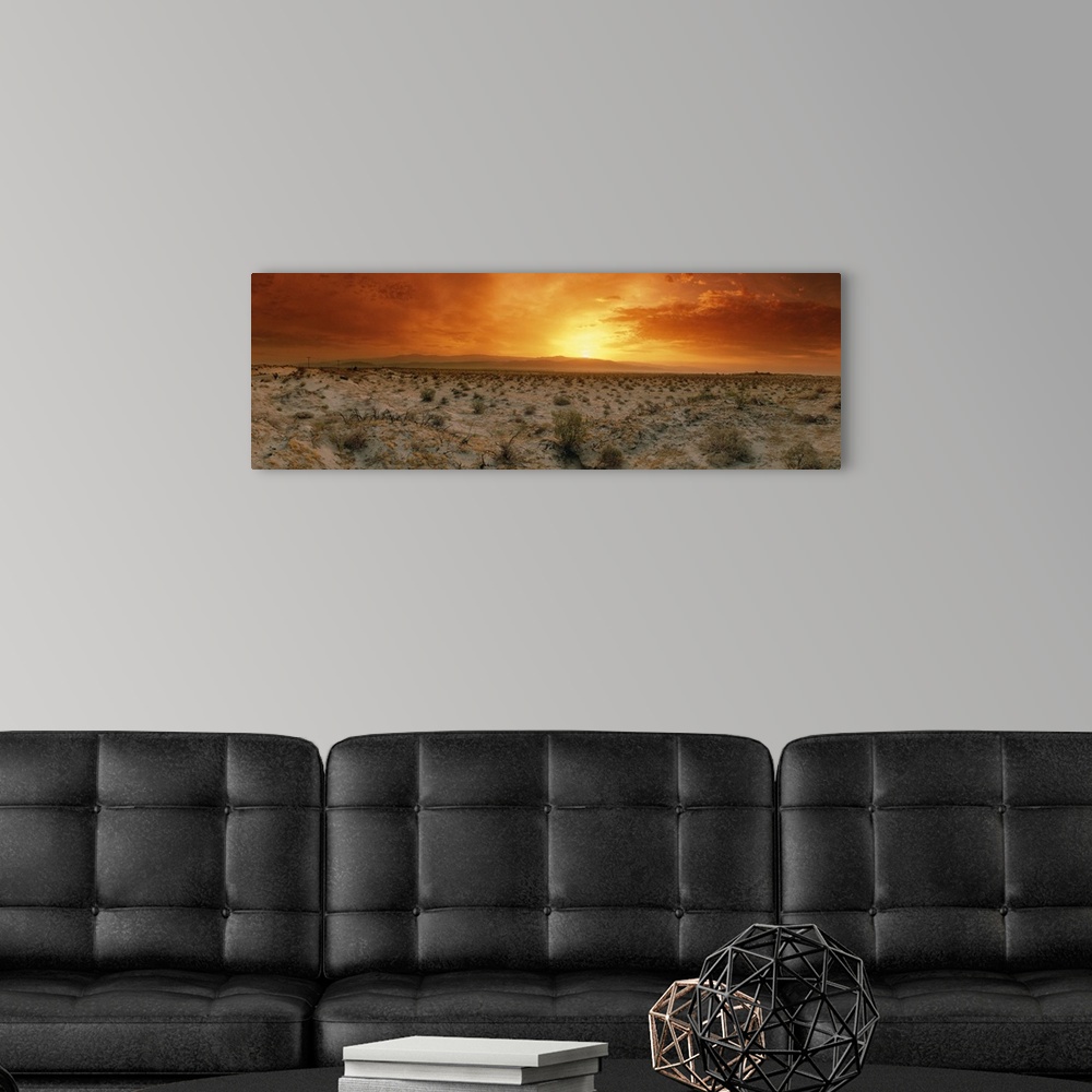 A modern room featuring Big, horizontal photograph of a fiery sunset over the desert in Palm Springs, California.