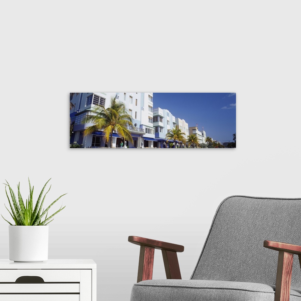 A modern room featuring Palm trees in front of buildings, Art Deco Hotel, Ocean Drive, Miami Beach, Florida