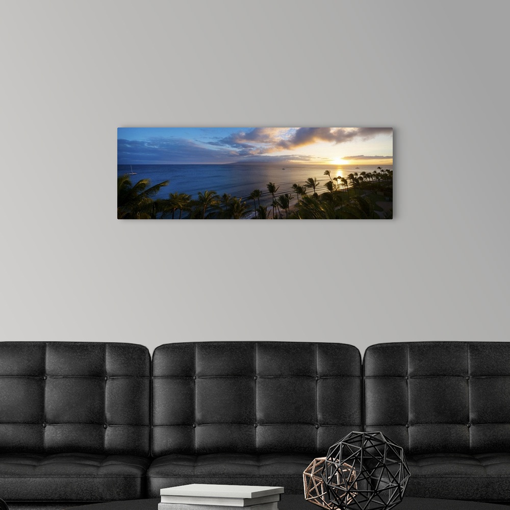 A modern room featuring Palm trees on the beach at dusk, Kaanapali, Maui, Hawaii, USA.